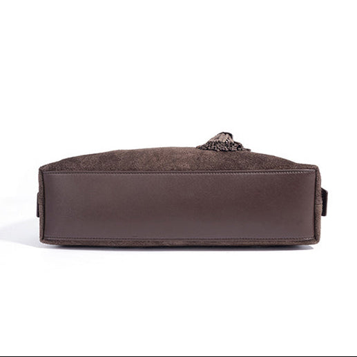 Brown leather bag shown from side and bottom angles on a white background