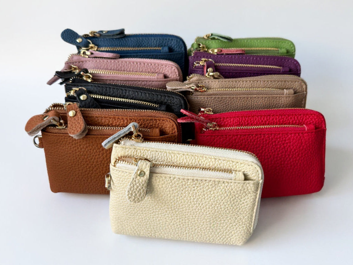 Collection of various colored leather wallets on a white background